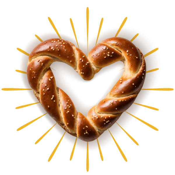 Heart shaped soft pretzel with yellow graphic rays around the outside.