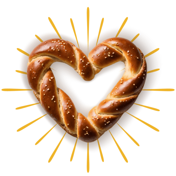 Heart shaped soft pretzel with yellow graphic rays around the outside.